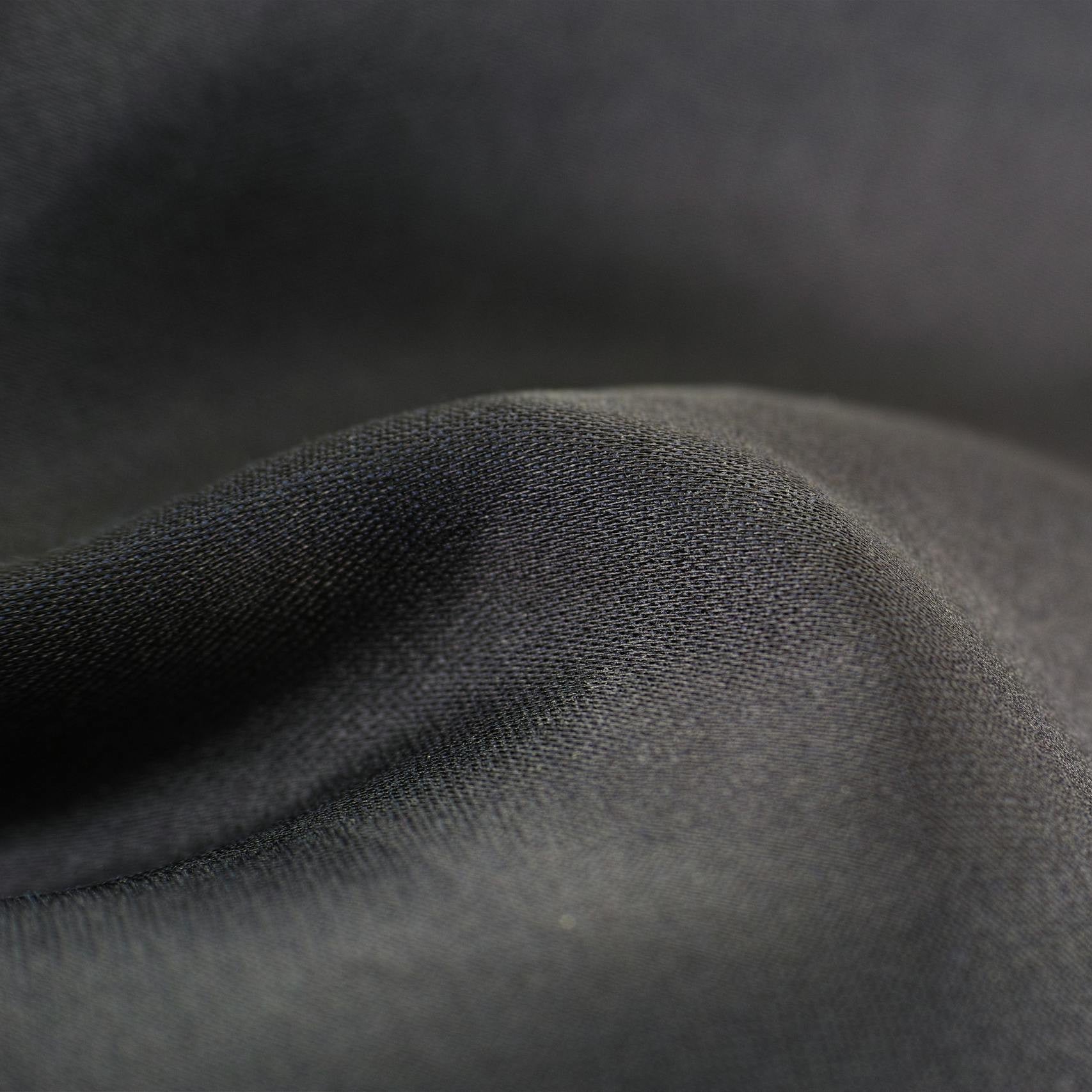 Grey knit fabric draped in soft folds.